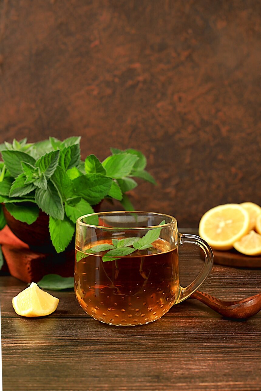 Medicinal herbal tea or infusion of peppermint with lemon with flowers, concept of alternative traditional medicine, collection of useful herbs for treatment according to folk recipes,