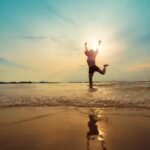 freedom asian beautiful woman  happiness jump and dance with sunset beach background