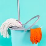 Web - sujeira em casa Set or Collection of Bucket, Mop and Cleaning Supplies On Turquoise Background Indoors.Vertical Image Orientation